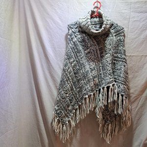 Woman's knitted poncho with high neck